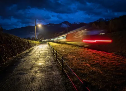 Intercity train passing the back lanes near Faulensee