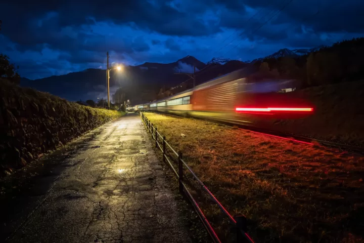 Intercity train passing the back lanes near Faulensee